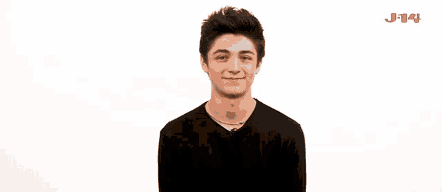a young man in a black shirt is smiling in front of a white background with j-14 written on it