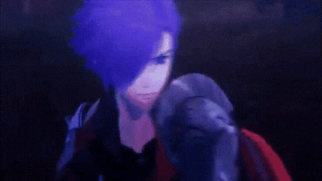 a blurry image of a person 's face with a purple background