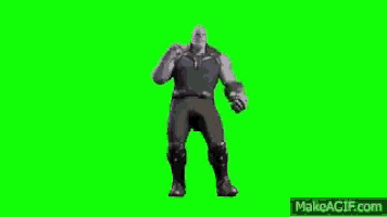 a man in a suit is dancing on a green screen .