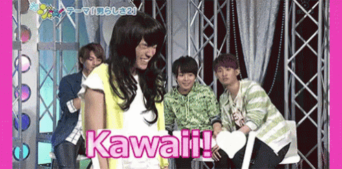 a group of young men are on a stage and one of them is wearing a wig and the word kawaii is on the screen .