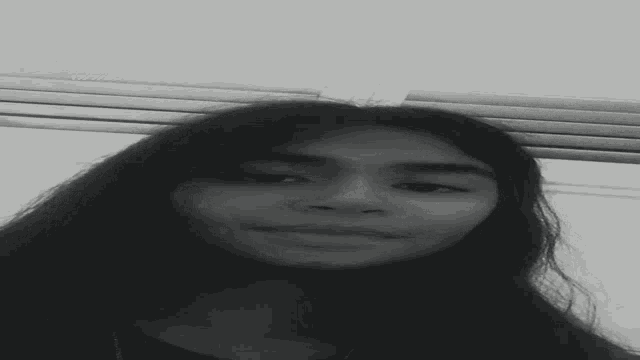 a black and white photo of a girl with long hair taken on 1/7/20