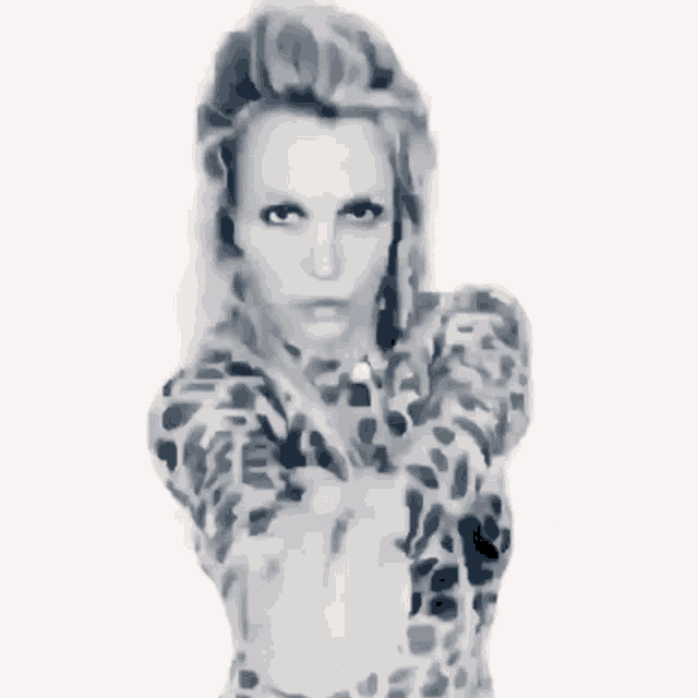 a black and white photo of a woman in a leopard print jacket