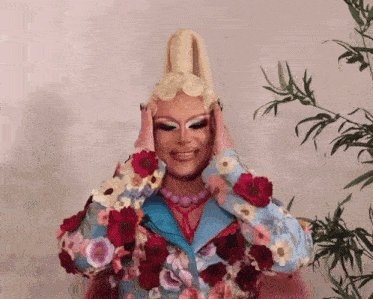 a drag queen covering her face with her hands