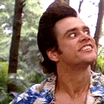 a man wearing a hawaiian shirt is smiling and looking up