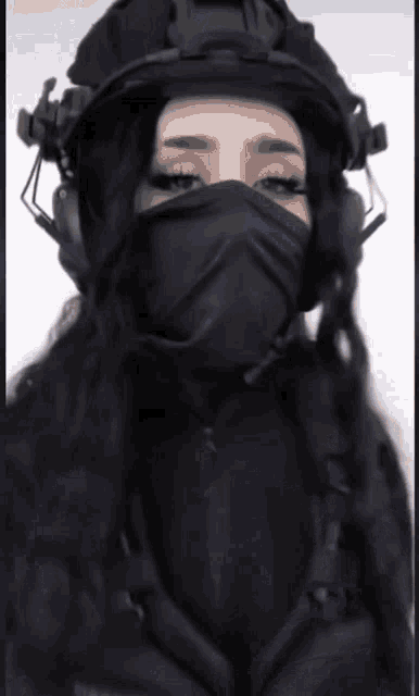 a woman wearing a mask and a helmet with headphones