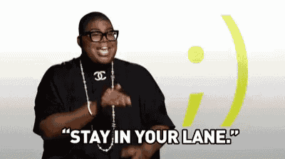 a man wearing glasses and a chanel necklace is saying " stay in your lane "