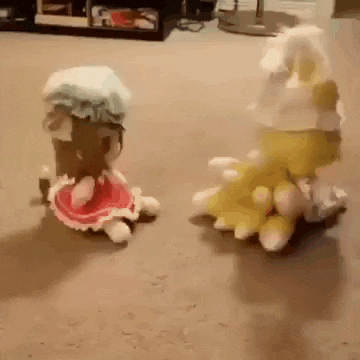two stuffed animals are sitting next to each other on a carpet in a living room .