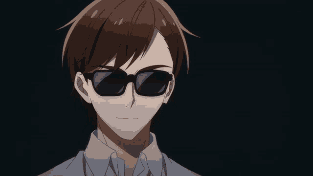 a man wearing sunglasses and a white shirt is looking at the camera