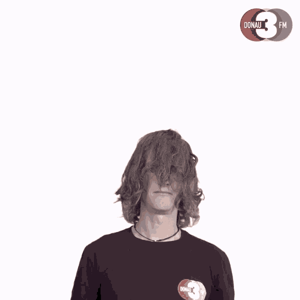 a man wearing sunglasses and a shirt that says donau 3 fm gives a thumbs up
