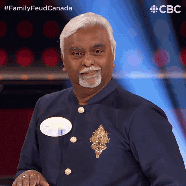 a man with a name tag on his chest is standing in front of a cbs logo