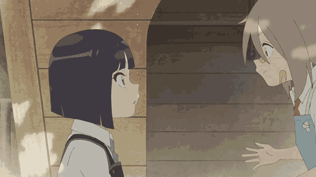 a girl with short hair is talking to another girl with long hair