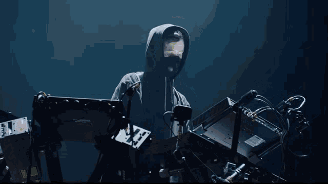 a man in a hoodie is playing a keyboard with a yamaha logo