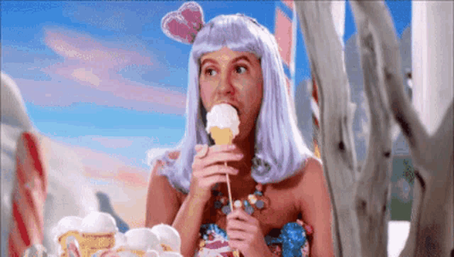 a woman in a purple wig is eating ice cream