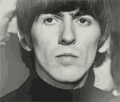 a black and white photo of a young man with a turtleneck