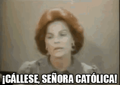 a woman with red hair is standing in front of a wall and says `` callese , señora catolica '' .