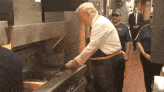 a man in a mcdonald 's uniform is cooking french fries