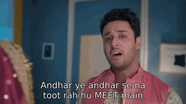 a man in a pink vest says andhar ye andhar se na toot rah hu meet main in front of a woman