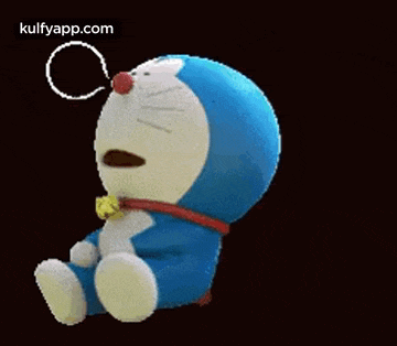 doraemon is sitting down and sleeping with his eyes closed and a bell around his neck .