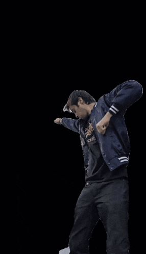 a man wearing a dodgers t-shirt is dancing