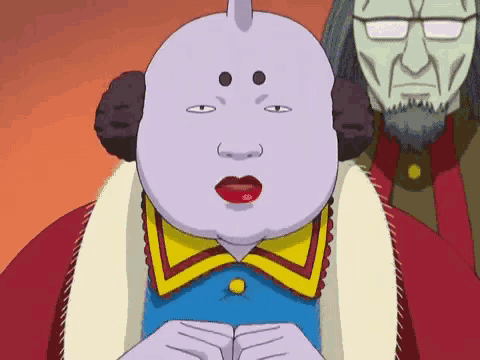 a cartoon character with a purple face and red lips is sitting in front of a man with glasses .