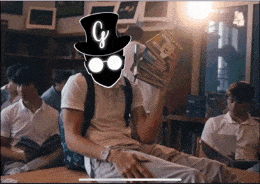 a man in a top hat holds a stack of books over his head with the letter g on it