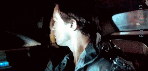 a close up of a man 's face with the year 2003 on the bottom right