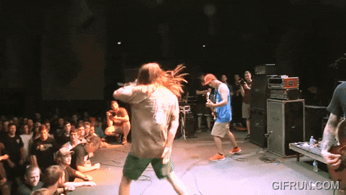 a crowd of people watching a band on stage with gifrun.com in the lower right corner