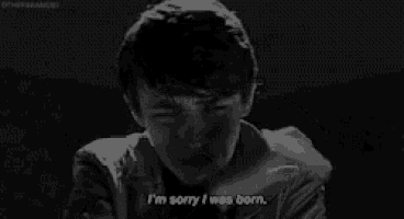 a black and white photo of a man crying and saying i 'm sorry i was born .