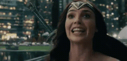 a close up of a woman in a wonder woman costume smiling .
