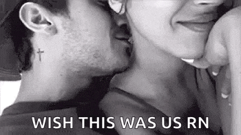 a man and a woman are kissing in a black and white photo . the man has a cross tattoo on his neck .