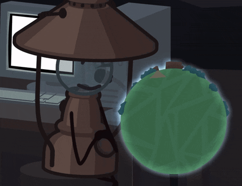 a computer monitor is behind a lamp and a green globe