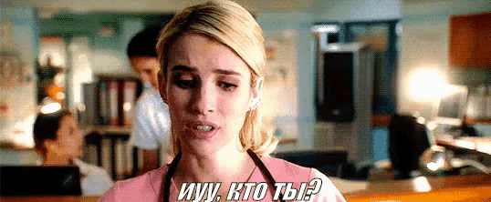 a woman in a pink shirt and apron is talking in a foreign language