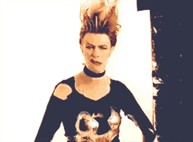 a woman making a funny face with her hair flying in the air