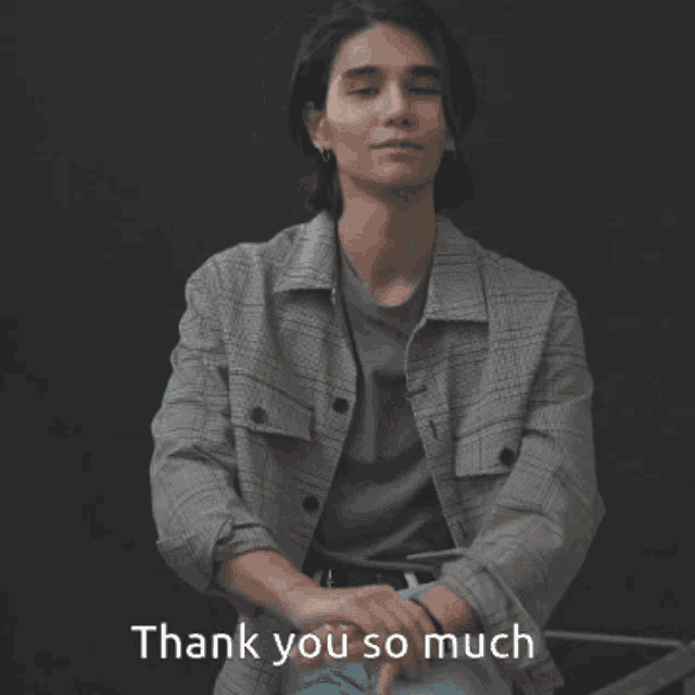 a man wearing a plaid jacket and a blue shirt says thank you so much