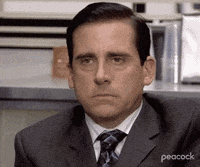 a man in a suit and tie is sitting in an office .