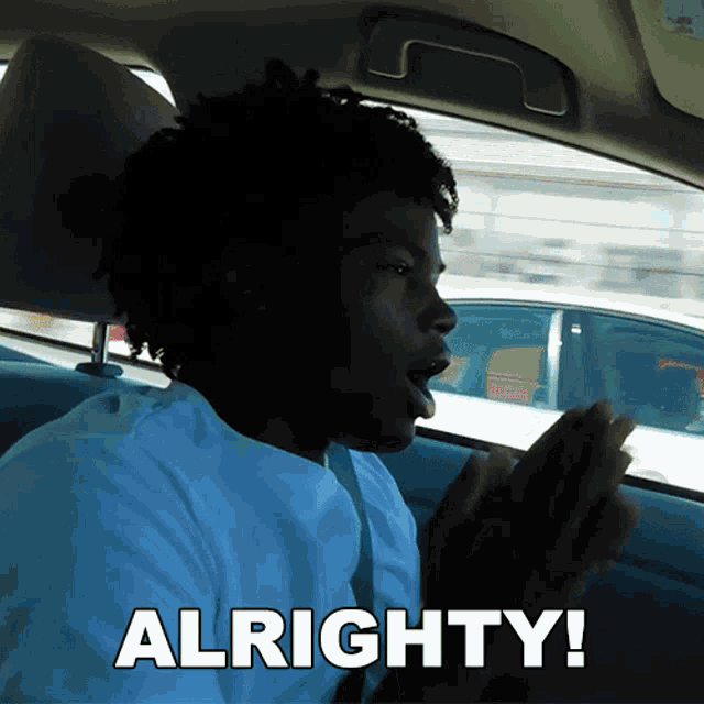 a man in a car says " alrighty " while looking out the window