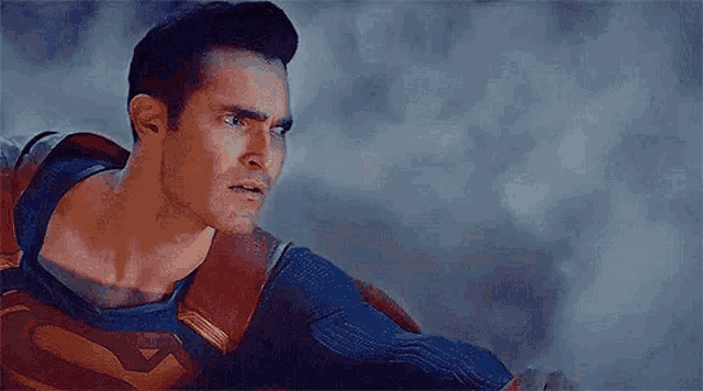 a close up of a man in a superman costume looking at something .