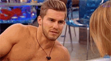 a shirtless man is talking to a woman while wearing headphones