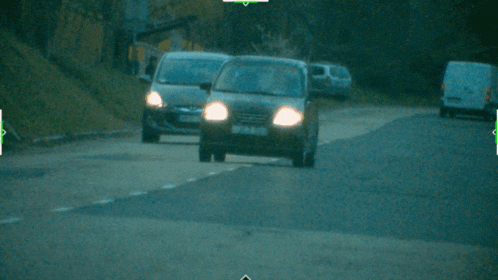 two cars are driving down a road and one has a license plate that starts with the letter p