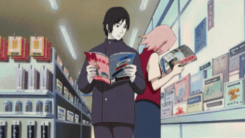 a man and a woman are standing in a store reading magazines