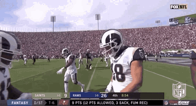 a football game between the saints and the rams