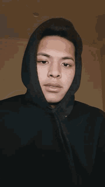 a young man wearing a black hoodie with nyork written on the front