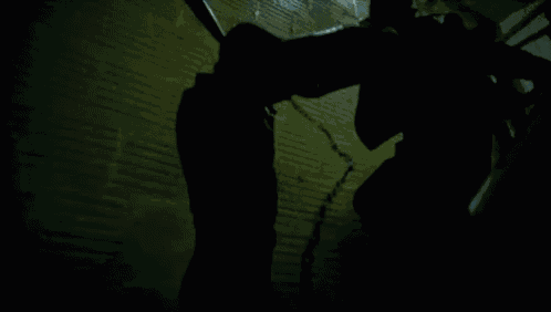 a man is holding a baseball bat in his hand while walking down stairs .