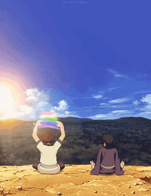 two people sitting on top of a hill looking at a rainbow