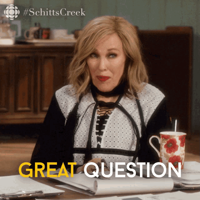 a poster for schitts creek shows a woman sitting at a desk with papers and a cup of coffee