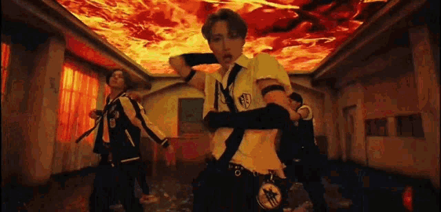 a group of young men are dancing in a room with a red ceiling .