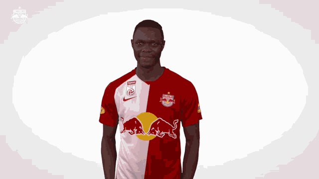 a man wearing a red and white jersey with a bull on it