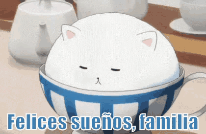 a white cat is sitting in a blue and white bowl with the words felices suenos familia below it