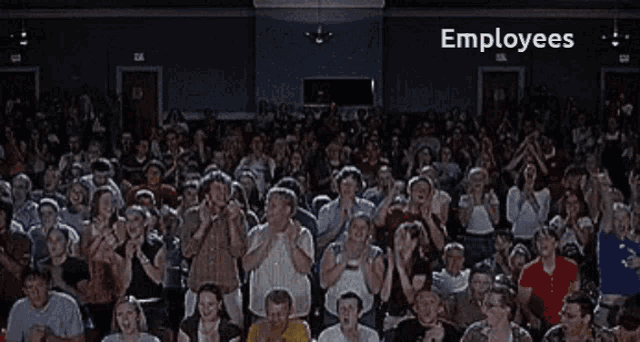 a large group of people standing in a room with the word employees above them