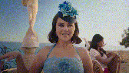 a woman in a blue dress with a blue flower on her hat
